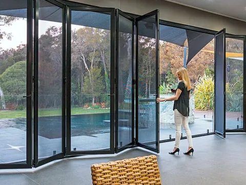 Bi-fold security doors opening onto a pool, the install Guardian shows for its 2018 Winner of Australia's Best Installation Award, National Security Screen Association