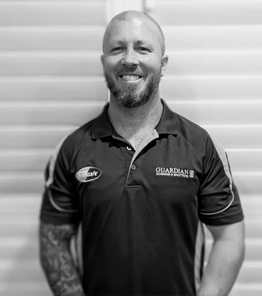 Clinton, a Guardian Screens & Shutters installer, in a Guardian work shirt